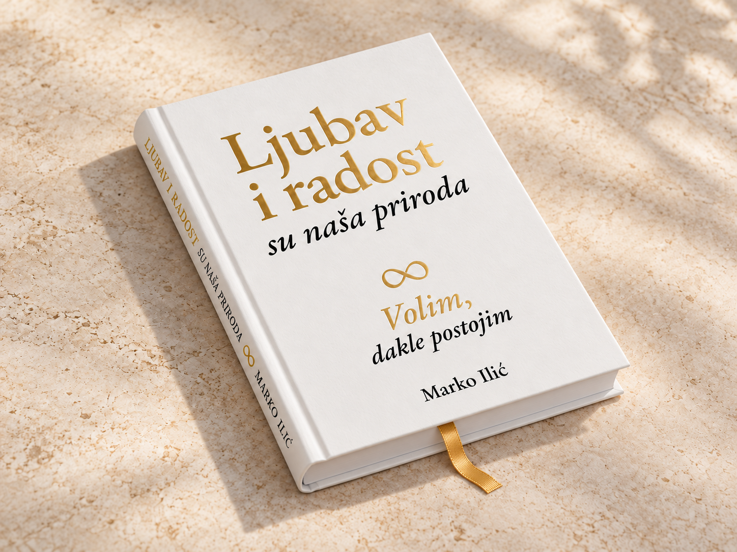 Knjiga u belom tvrdom povezu, detalj zlatotiska i zlatne trake